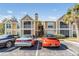 Charming condo exterior with red roof, screened porch, landscaping, and reserved parking at 9481 Highland Oak Drive # 602, Tampa, FL 33647