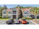 Inviting exterior of the condo showing its red roof, trees, and parking spaces at 9481 Highland Oak Drive # 602, Tampa, FL 33647