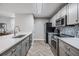 Modern kitchen with stainless steel appliances, sleek countertops, and herringbone flooring at 9481 Highland Oak Drive # 602, Tampa, FL 33647