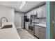 Contemporary kitchen featuring stainless steel appliances, quartz countertops, and modern backsplash at 9481 Highland Oak Drive # 602, Tampa, FL 33647