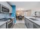 Bright kitchen with stainless steel appliances, sleek counters, open to dining area at 9481 Highland Oak Drive # 602, Tampa, FL 33647