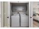Convenient laundry room with modern washer and dryer, plus overhead cabinet storage at 9481 Highland Oak Drive # 602, Tampa, FL 33647