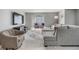 Cozy living space with a gray sectional couch, a media cabinet, and tile floors at 9481 Highland Oak Drive # 602, Tampa, FL 33647