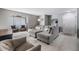 Spacious living room with grey sectional sofa, modern decor, and tile flooring at 9481 Highland Oak Drive # 602, Tampa, FL 33647