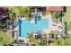 Aerial view of a large community pool surrounded by lounge chairs and tropical landscaping at 9481 Highland Oak Drive # 602, Tampa, FL 33647