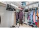 A well-organized walk-in closet with ample storage space and shelves, including a mirror for convenience at 9481 Highland Oak Drive # 602, Tampa, FL 33647