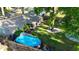 Aerial view of backyard with pool, patio, landscaping, mature trees, and a fence at 9616 Oak Ridge Ave, Riverview, FL 33578