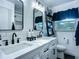 Modern bathroom with double sink vanity, black fixtures, and a decorative ladder shelf at 9616 Oak Ridge Ave, Riverview, FL 33578