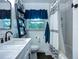 Renovated bathroom with subway tile, updated fixtures, and a stylish ladder shelf at 9616 Oak Ridge Ave, Riverview, FL 33578