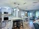 Charming dining area with white table and chairs adjacent to a kitchen at 9616 Oak Ridge Ave, Riverview, FL 33578