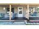Charming front porch with swing and chairs offers a cozy welcome at 9616 Oak Ridge Ave, Riverview, FL 33578