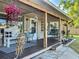 Inviting covered front porch with seating and charming decorative accents at 9616 Oak Ridge Ave, Riverview, FL 33578