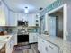 Well-equipped kitchen featuring white cabinets, granite countertops and new appliances at 9616 Oak Ridge Ave, Riverview, FL 33578