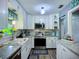 Modern kitchen with white cabinets, stainless steel appliances, and granite countertops at 9616 Oak Ridge Ave, Riverview, FL 33578
