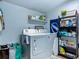 Functional laundry room featuring a modern washer and dryer, plus shelving for storage at 9616 Oak Ridge Ave, Riverview, FL 33578