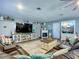 Cozy living room featuring a brown sofa, fireplace, and a display cabinet at 9616 Oak Ridge Ave, Riverview, FL 33578