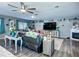 Spacious living room with a ceiling fan, fireplace, and a large entertainment center at 9616 Oak Ridge Ave, Riverview, FL 33578