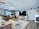 Spacious living room with a fireplace, flat screen TV, and grey walls at 9616 Oak Ridge Ave, Riverview, FL 33578