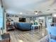 Spacious living room featuring hardwood floors, a large sectional sofa, and ample natural light at 9616 Oak Ridge Ave, Riverview, FL 33578