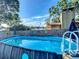Above ground pool surrounded by decorative fence, creating a serene backyard oasis at 9616 Oak Ridge Ave, Riverview, FL 33578