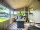 Comfortable enclosed porch with wicker chairs and outdoor views, great for relaxation at 9616 Oak Ridge Ave, Riverview, FL 33578