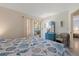 Bright bedroom with seaside-themed bedding, a blue dresser, and access to the screened-in patio at 100 Glennes Ln # 207, Dunedin, FL 34698