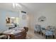 Open-concept dining area with seating and decorative details connects to the kitchen at 100 Glennes Ln # 207, Dunedin, FL 34698
