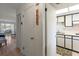 Hallway view towards kitchen, and living area with a closet and wall decor at 100 Glennes Ln # 207, Dunedin, FL 34698