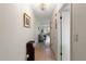 Bright hallway with tile and wood flooring leading to a living area with natural light at 100 Glennes Ln # 207, Dunedin, FL 34698