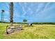 Scenic view of John Grant Hubbard Park with benches overlooking the water, perfect for enjoying nature and outdoor activities at 100 Glennes Ln # 207, Dunedin, FL 34698