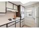 Well-lit kitchen equipped with sleek countertops, white appliances, and ample cabinet space at 100 Glennes Ln # 207, Dunedin, FL 34698