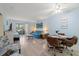 Comfortable living room with ample seating, ceiling fan, and sliding door to screened balcony at 100 Glennes Ln # 207, Dunedin, FL 34698