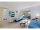 Cozy living room with sliding doors, a TV, comfortable seating and ceiling fan at 100 Glennes Ln # 207, Dunedin, FL 34698