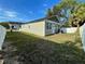 Large backyard with green grass and white fence at 107 E Park St, Tarpon Springs, FL 34689