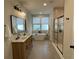 Bright bathroom with a soaking tub, double vanity, and glass-enclosed shower at 107 E Park St, Tarpon Springs, FL 34689