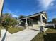 Angle view of the home showing the covered driveway and green exterior at 107 E Park St, Tarpon Springs, FL 34689