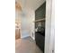 Chic laundry room with dark green tile accent wall, floating wood shelf, and black sink at 107 E Park St, Tarpon Springs, FL 34689