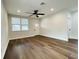 Bright living room with hardwood floors, ceiling fan, and a front door with sidelight windows at 107 E Park St, Tarpon Springs, FL 34689