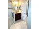 Bathroom featuring tiled floors, and vanity with granite counters and sleek finishes at 11344 Heritage Point Dr, Hudson, FL 34667