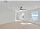 Bright and airy bedroom featuring carpeted floors, a ceiling fan, and ample natural light at 11817 Mango Cross Ct, Seffner, FL 33584