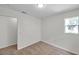 Bedroom with neutral carpet, white walls, a window, and door to another room at 11817 Mango Cross Ct, Seffner, FL 33584