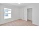 Bedroom with neutral carpet, white walls, a window, and a closet at 11817 Mango Cross Ct, Seffner, FL 33584