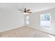 Bright bedroom with ample natural light, carpet flooring and a modern ceiling fan at 11817 Mango Cross Ct, Seffner, FL 33584