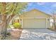 Inviting single Gathering home featuring a well-manicured lawn, mature landscaping, and a two-car garage at 11817 Mango Cross Ct, Seffner, FL 33584