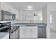 Clean kitchen featuring modern appliances, white cabinetry, and contrasting countertops at 11817 Mango Cross Ct, Seffner, FL 33584