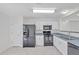 Bright kitchen featuring a modern appliances, white cabinets and sleek countertops at 11817 Mango Cross Ct, Seffner, FL 33584
