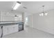 Open concept kitchen and dining room with modern lighting and neutral colors at 11817 Mango Cross Ct, Seffner, FL 33584
