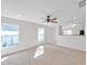 Well-lit living room featuring fresh white walls and carpeted flooring, perfect for relaxation and comfort at 11817 Mango Cross Ct, Seffner, FL 33584