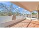 Screened-in brick patio, perfect for outdoor living and entertaining with a view of the green surroundings at 11817 Mango Cross Ct, Seffner, FL 33584