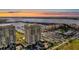 Aerial view of the building, parking, surrounding area, and waterway at 130 Riviera Dunes Way # 203, Palmetto, FL 34221